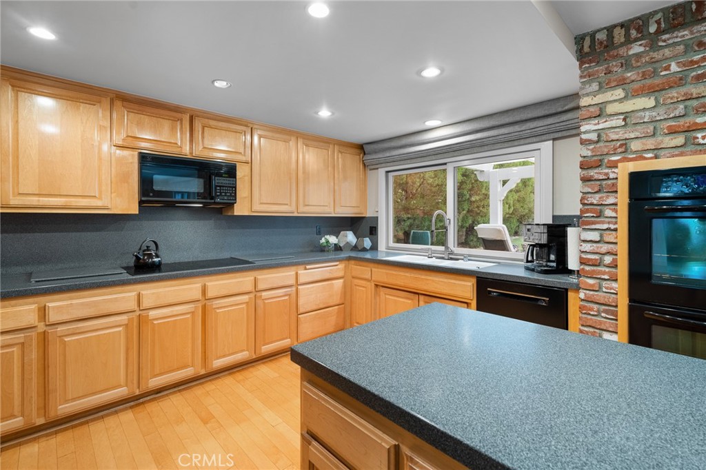 18927 Granada Circle Porter Ranch, CA 91326 - Photo 27 of 75 a kitchen with stainless steel appliances granite countertop a sink a stove a microwave and island