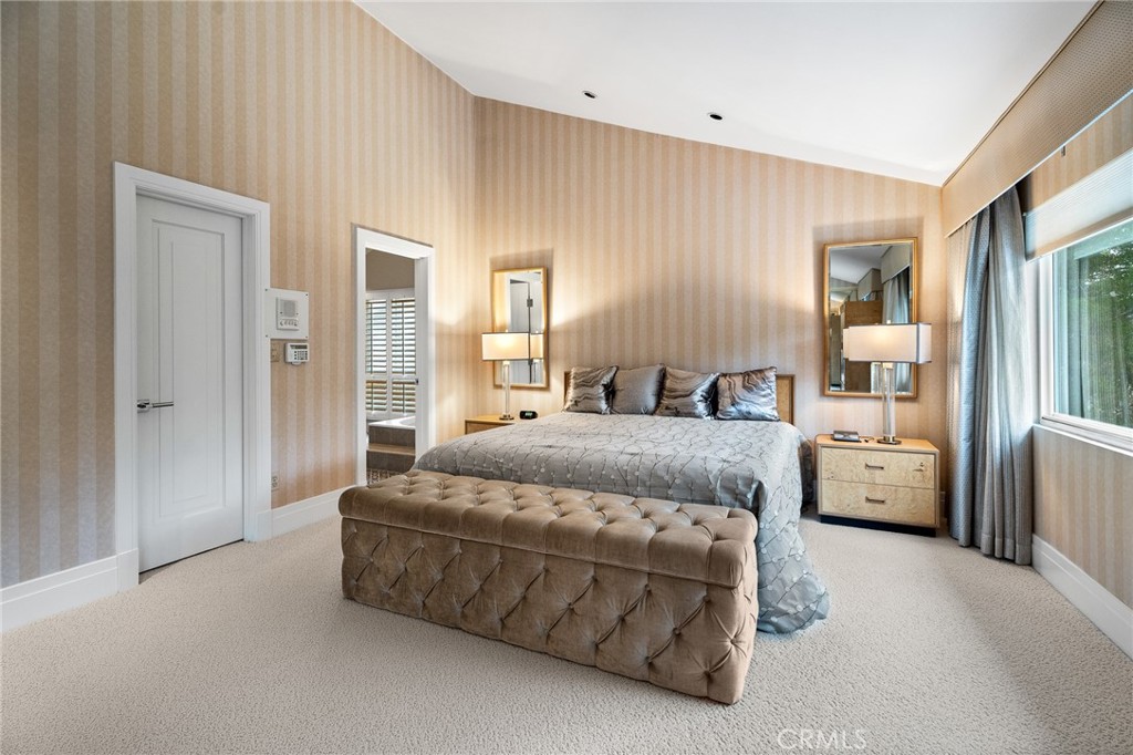 18927 Granada Circle Porter Ranch, CA 91326 - Photo 36 of 75 a spacious bedroom with a bed and a large mirror