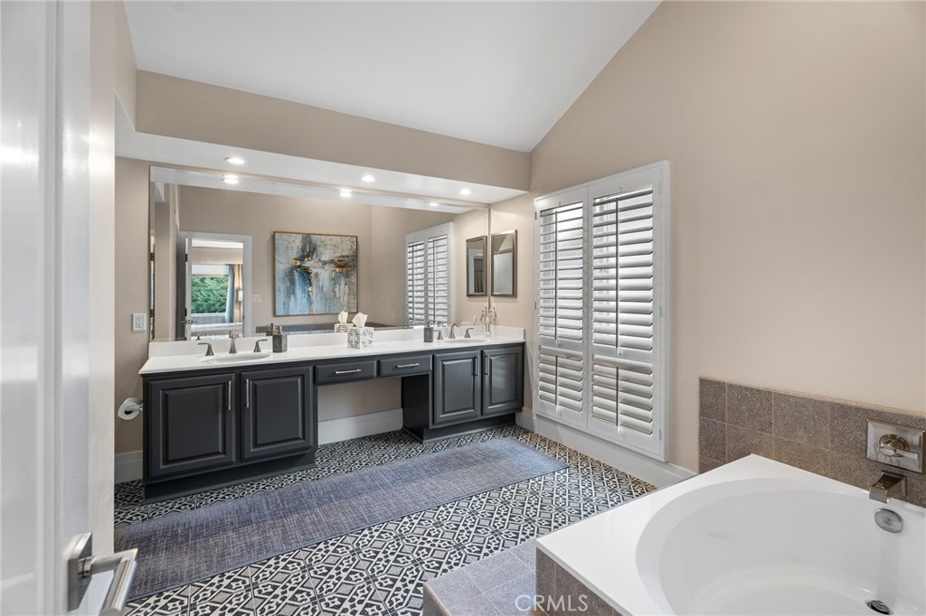 18927 Granada Circle Porter Ranch, CA 91326 - Photo 39 of 75 a large bathroom with a sink a mirror and a bathtub