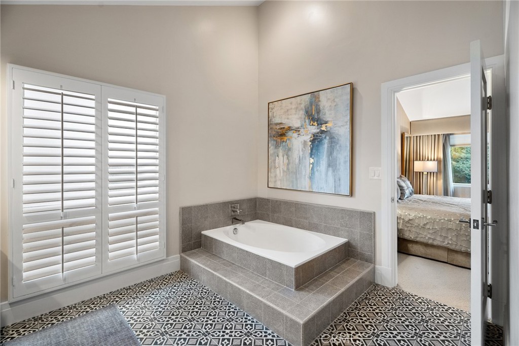 18927 Granada Circle Porter Ranch, CA 91326 - Photo 40 of 75 a spacious bedroom with a bed and a window