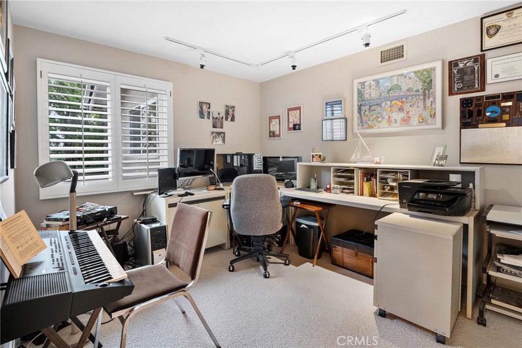 18927 Granada Circle Porter Ranch, CA 91326 - Photo 49 of 75 a view of a workspace with furniture and a window