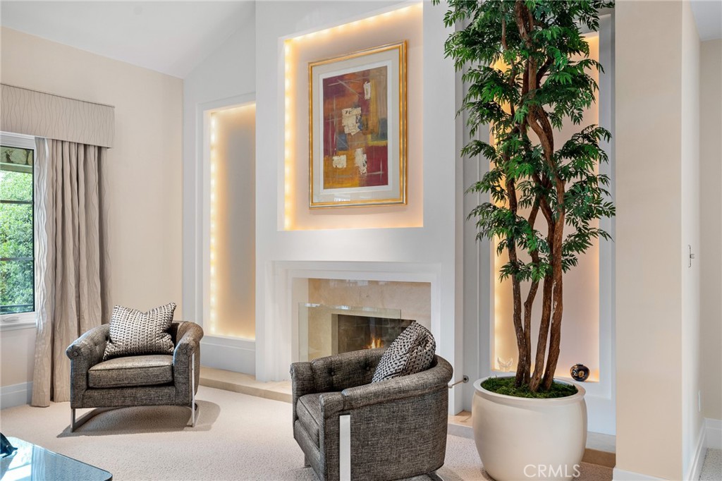 18927 Granada Circle Porter Ranch, CA 91326 - Photo 6 of 75 a living room with furniture a potted plant and a fireplace