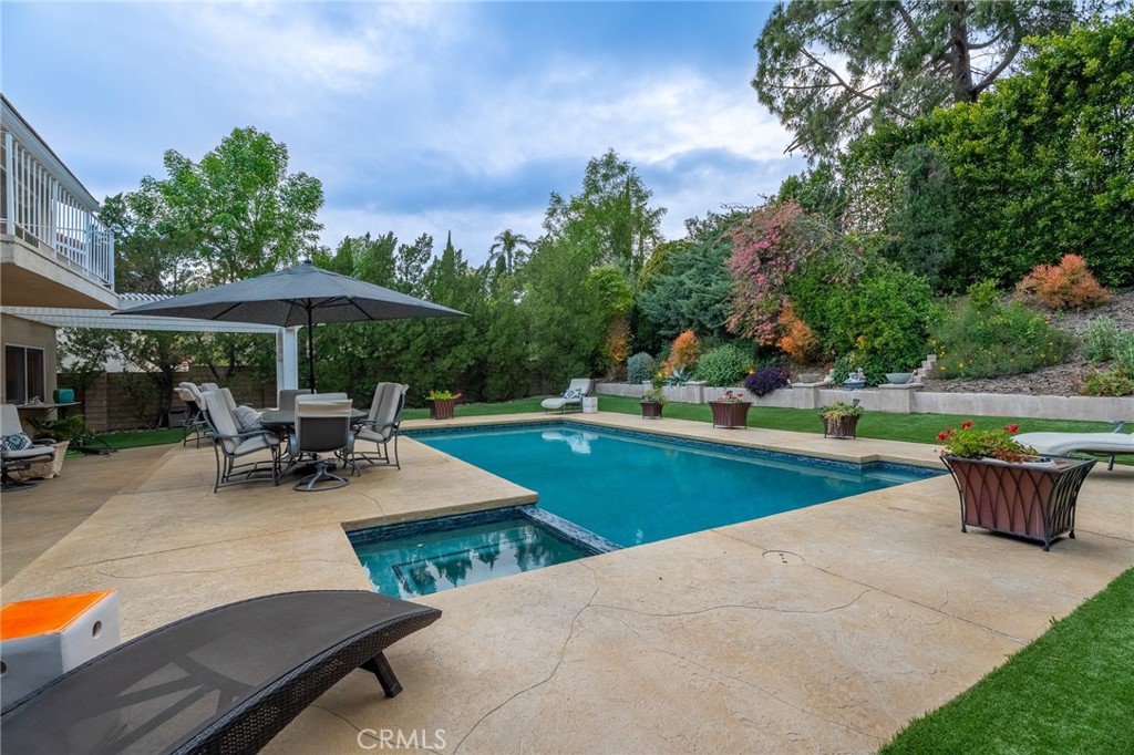 18927 Granada Circle Porter Ranch, CA 91326 - Photo 63 of 75 a view of a patio with a table and chairs under an umbrella