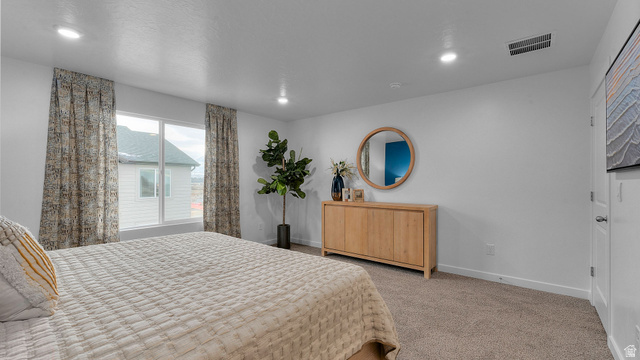 2032 East Dorset Way, Unit 286 Salem, UT 84653 - Photo 16 of 23 Spacious room featuring neutral carpeting, recessed lighting, a large window, white walls, and a built-in wooden cabinet