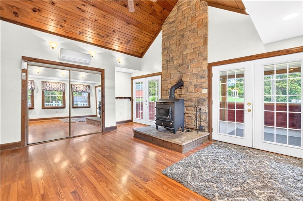 1301 Langeloth Road Burgettstown, PA 15021 - Photo 12 of 50 This family room/sun room is truly eye catching with it's stone fireplace and wood ceiling...