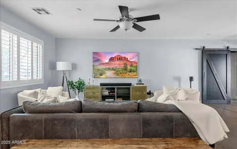 a living room with furniture a window and a flat screen tv