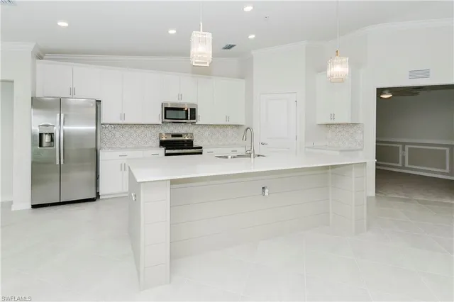 a kitchen with a refrigerator sink and microwave