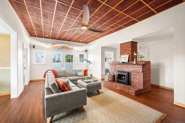 a living room with furniture a fireplace and a table