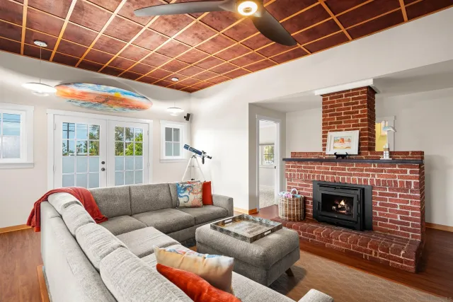 a view of a livingroom with furniture wooden floor and windows