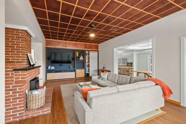 a living room with furniture a fireplace and a table