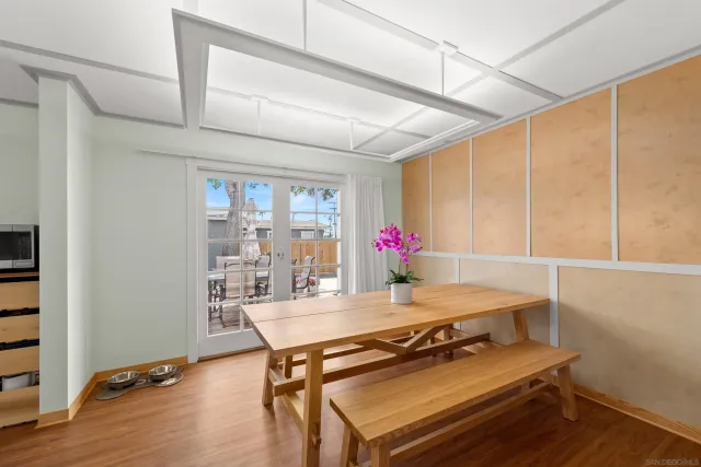 a dining room with kitchen island furniture and wooden floor