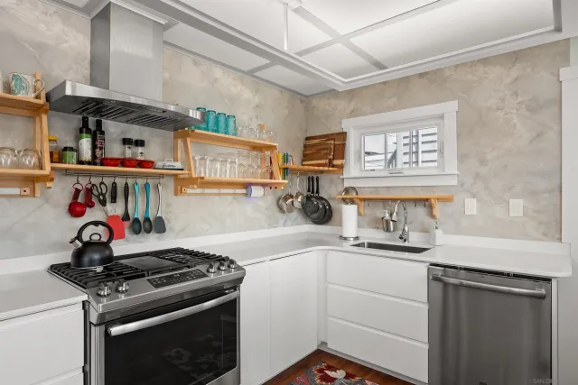 a kitchen with stainless steel appliances a sink and cabinets