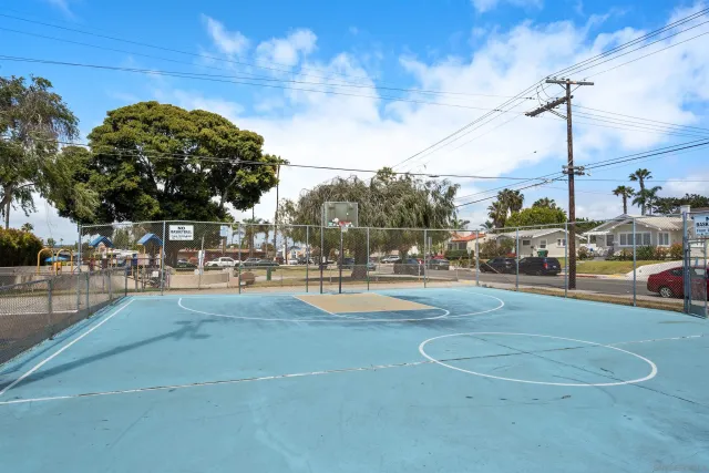 a view of a swimming pool with a patio and a yard