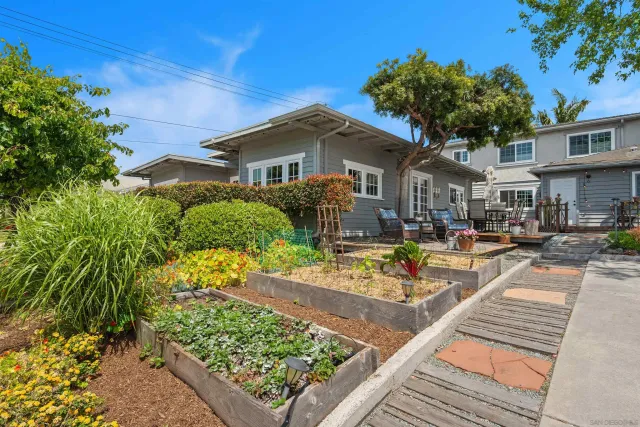 a front view of a house with a garden