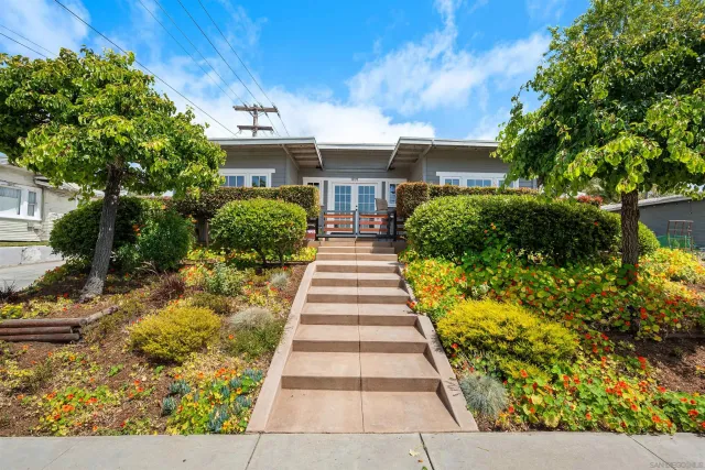 a front view of house with a garden