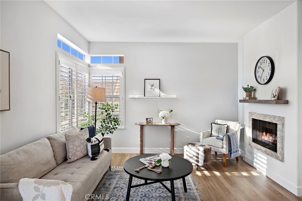 9 Violado Rancho Santa Margarita, CA 92688 - Photo 11 of 41 a living room with furniture a fireplace and a floor to ceiling window