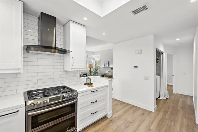 a kitchen with a stove and a refrigerator