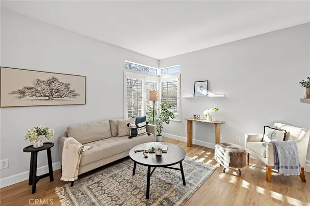 a living room with furniture a rug and a table