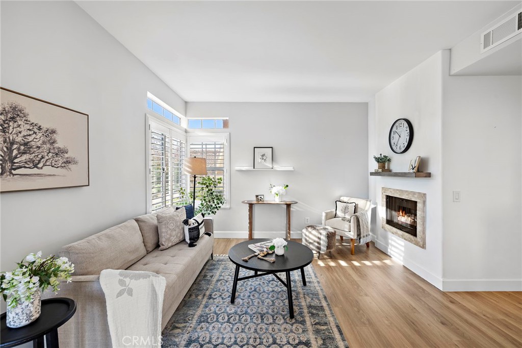 9 Violado Rancho Santa Margarita, CA 92688 - Photo 10 of 41 a living room with furniture a fireplace and wooden floor