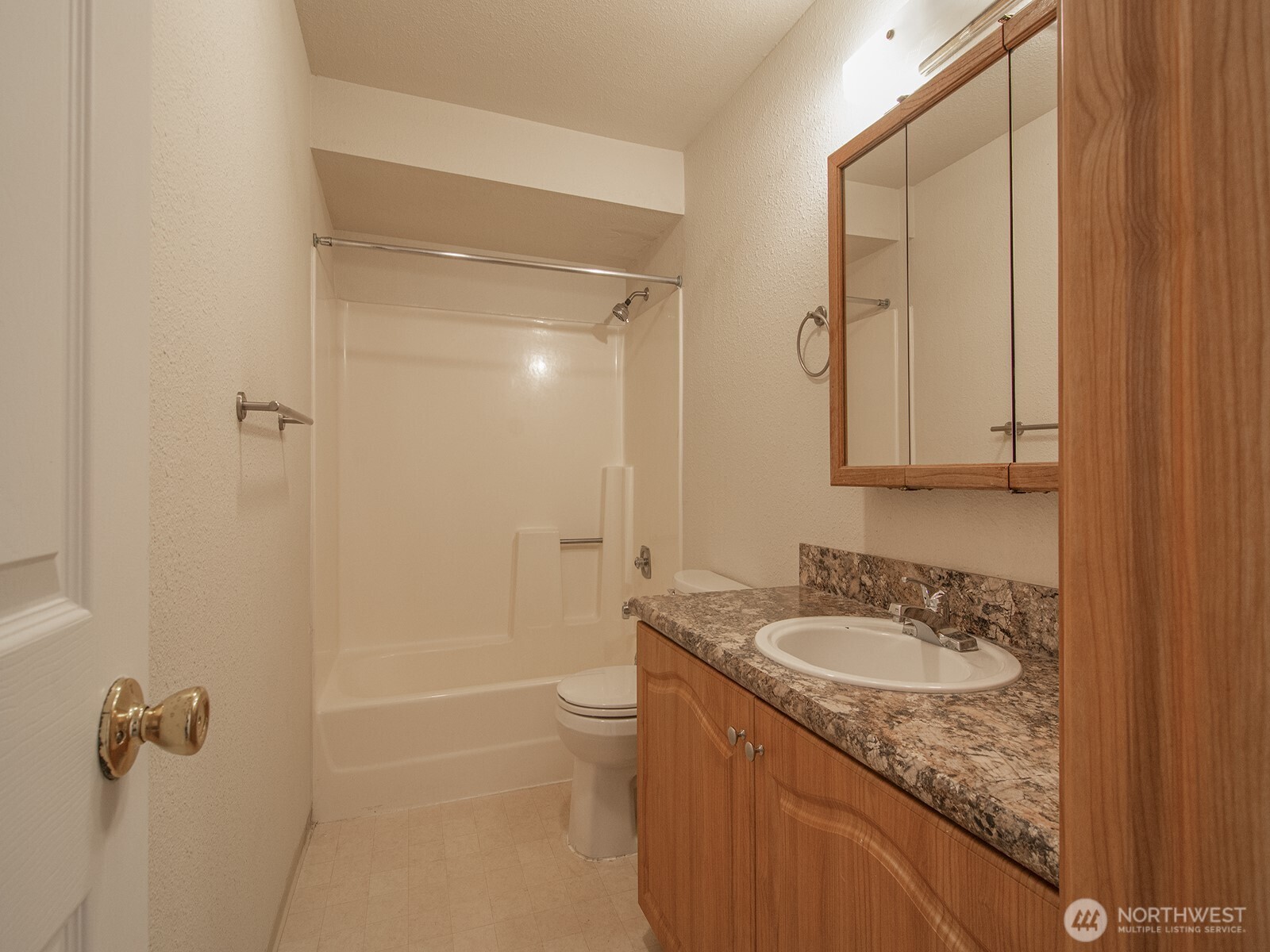14527 Northeast 40th Street, Unit G204 Bellevue, WA 98007 - Photo 13 of 17 a bathroom with a granite countertop sink a mirror and a shower