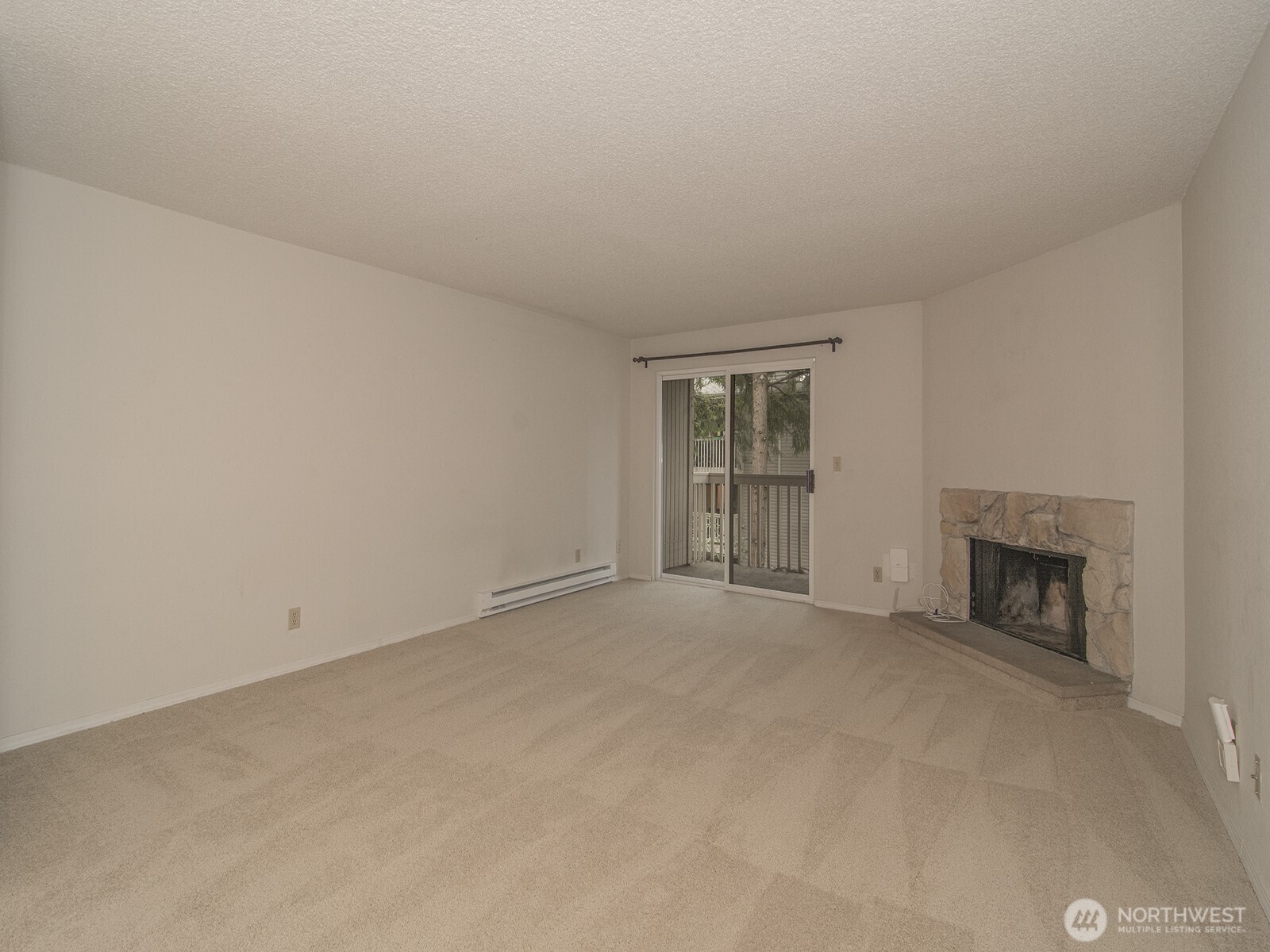 14527 Northeast 40th Street, Unit G204 Bellevue, WA 98007 - Photo 6 of 17 an empty room with fireplace