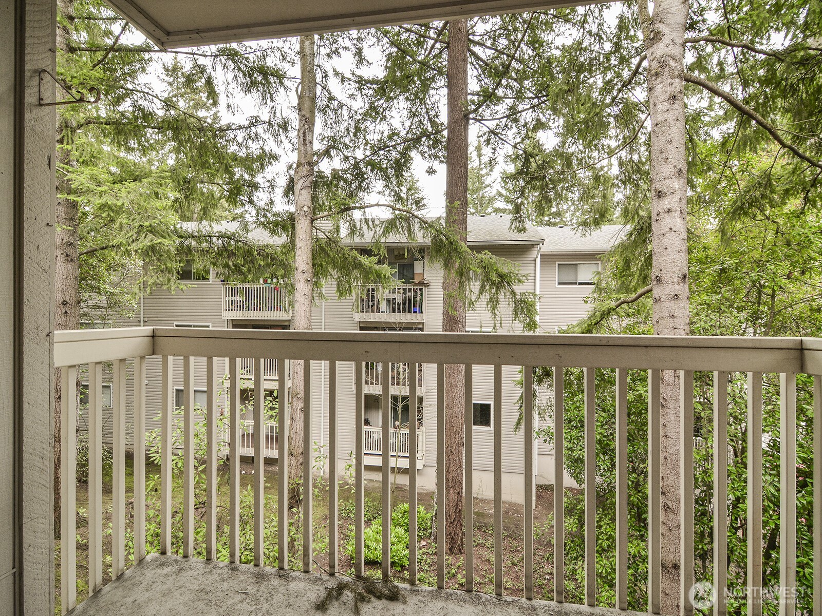 14527 Northeast 40th Street, Unit G204 Bellevue, WA 98007 - Photo 8 of 17 a view of a balcony with wooden fence and floor