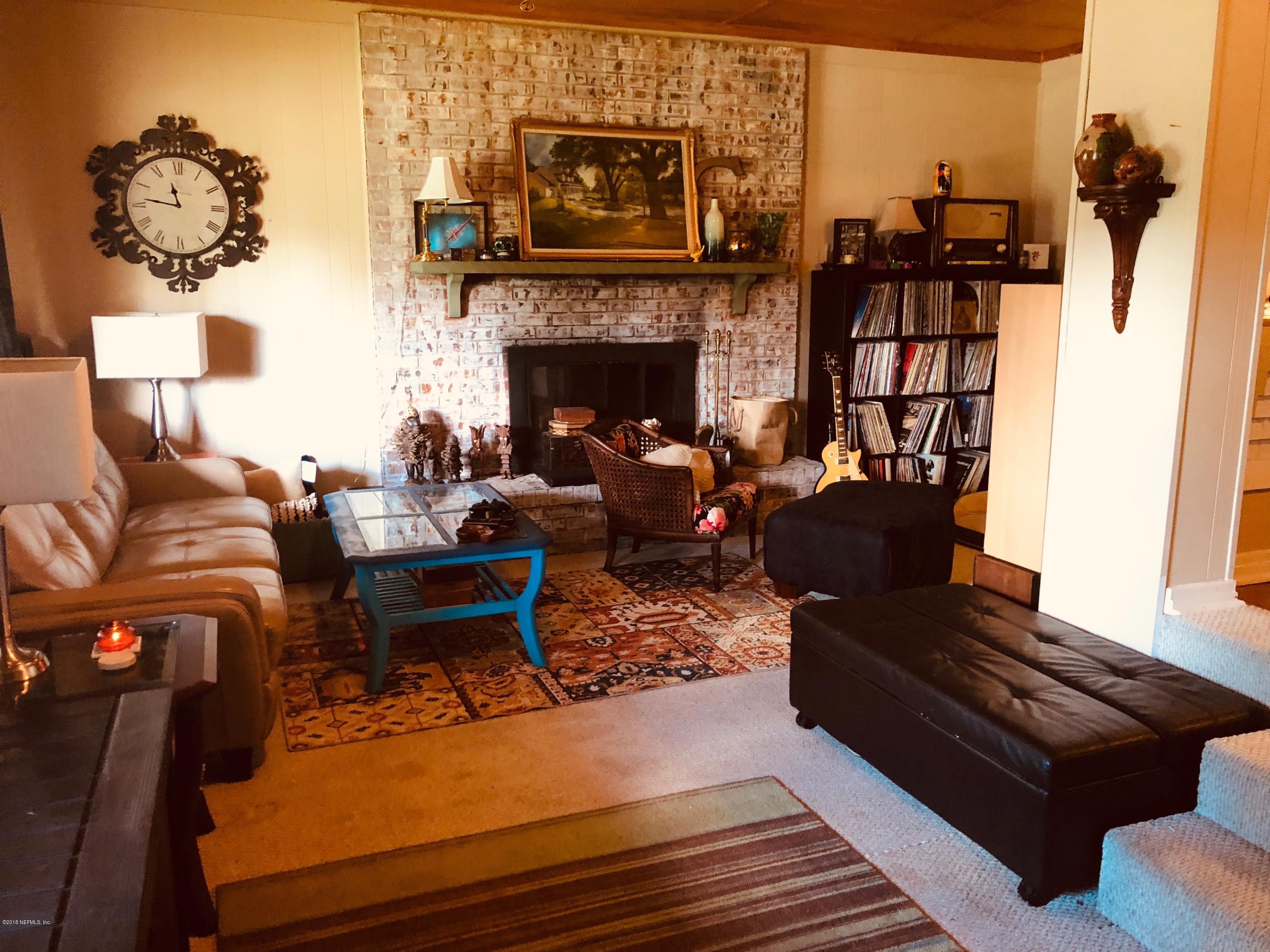 5461 Cardan Road Jacksonville, FL 32244 - Photo 5 of 8 a living room with furniture fireplace and rug