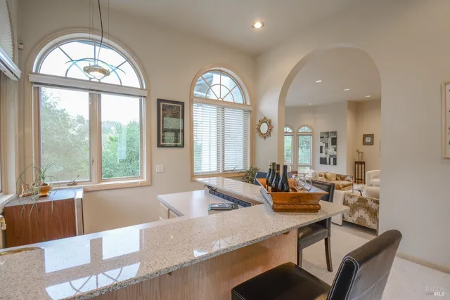 a kitchen with stainless steel appliances granite countertop a refrigerator and a stove