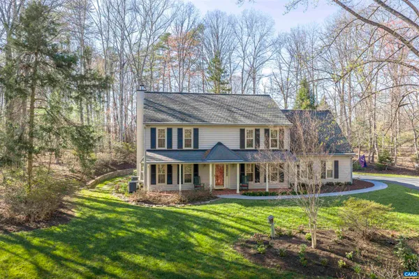 a front view of a house with a yard table and chairs