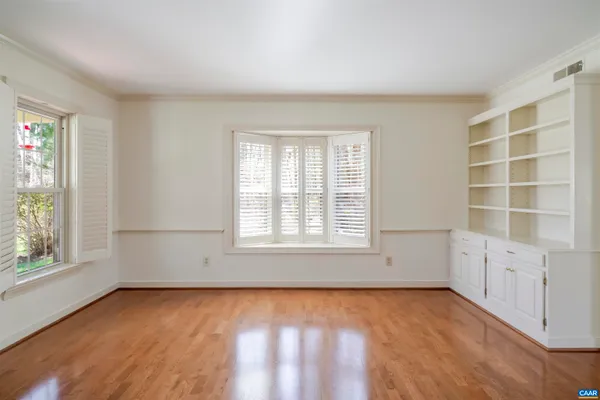 a bathroom with a granite countertop sink and a toilet
