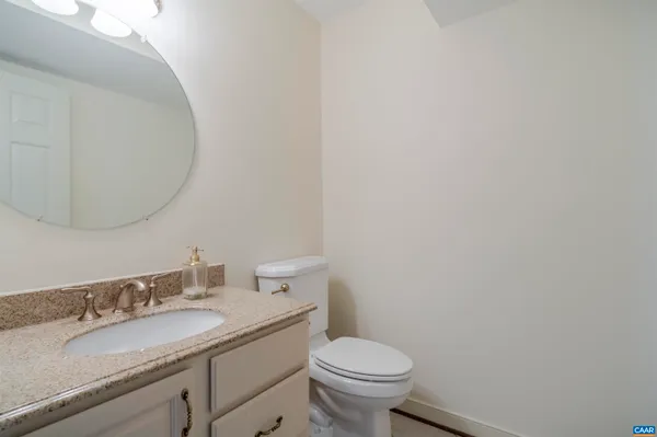 an empty room with wooden floor closet and windows