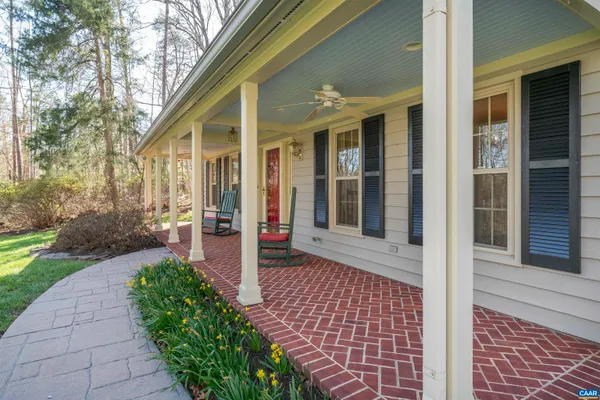 a view of a patio with table and chairs and potted plants