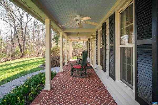 a view of backyard of house with outdoor seating and green space