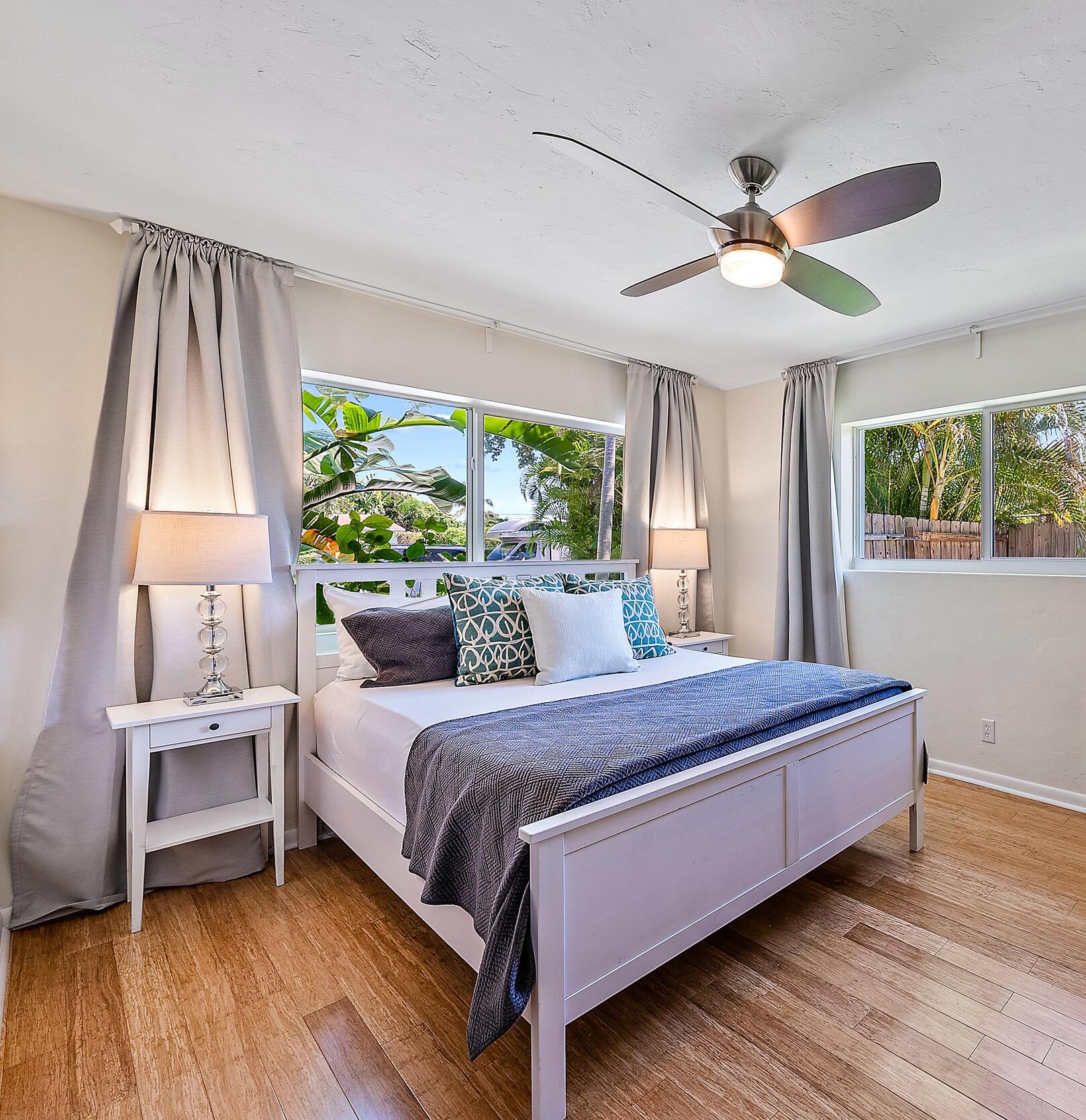 246 Gregory Road West Palm Beach, FL 33405 - Photo 15 of 20 a bedroom with a bed and a chandelier