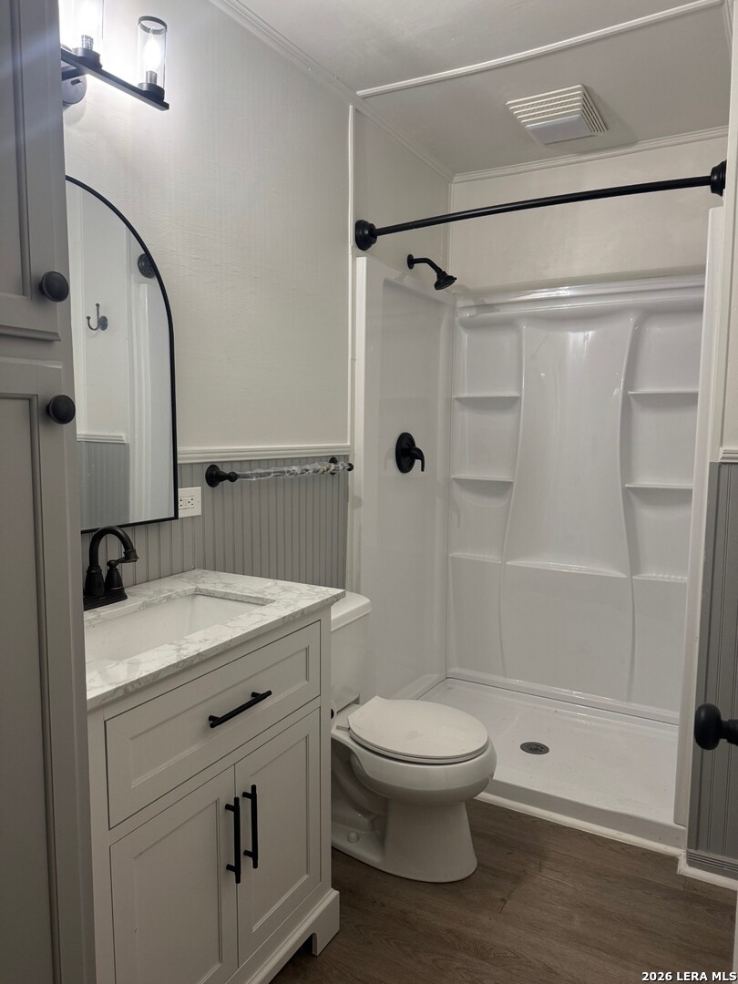 1510 12th Street Hondo, TX 78861 - Photo 11 of 14 a bathroom with a granite countertop sink toilet and shower