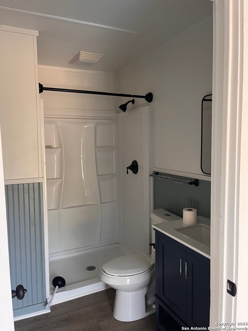 1510 12th Street Hondo, TX 78861 - Photo 7 of 14 a bathroom with a granite countertop bathtub shower sink mirror and toilet