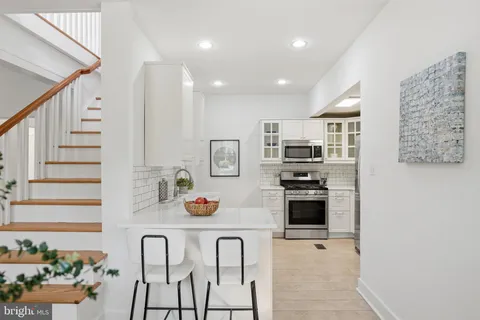 a kitchen with stainless steel appliances kitchen island granite countertop a refrigerator and microwave