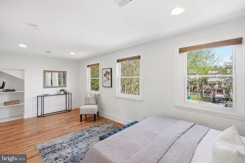 a bedroom with furniture and a window