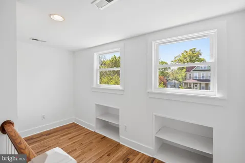 a view of room with window and wooden floor