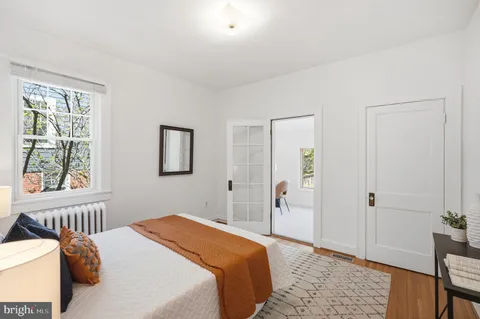 a bedroom with a bed and a window