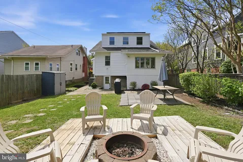a view of house with backyard outdoor seating and green space