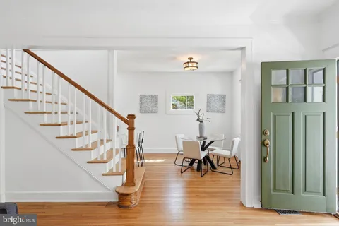 a view of entryway and hall with wooden floor