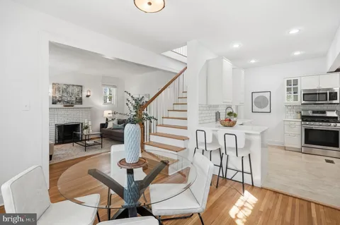 a dining room with furniture and wooden floor