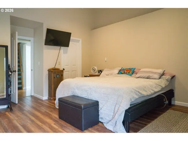 a bedroom with a bed and a flat screen tv