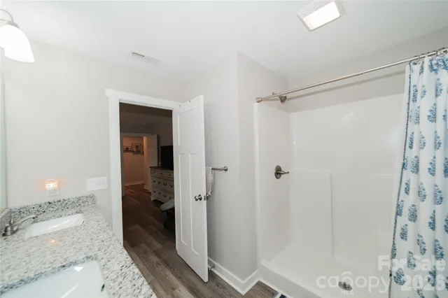 a bathroom with a shower and a sink