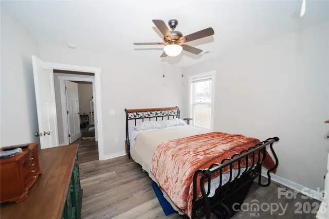 a bedroom with a bed a window and closet