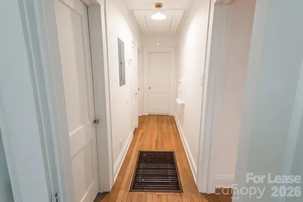 a view of a room with wooden floor and white walls