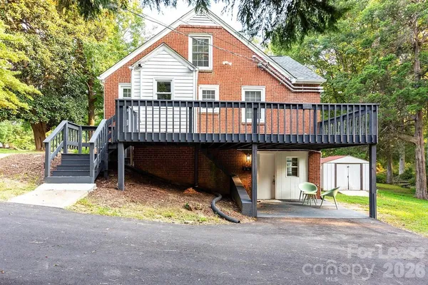 a view of a house with a yard and sitting area