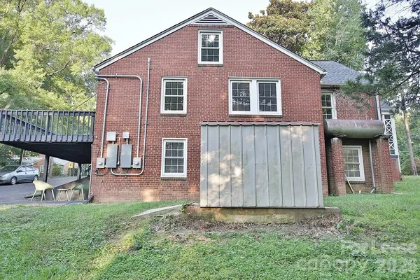 a view of empty room with wooden floor and fireplace