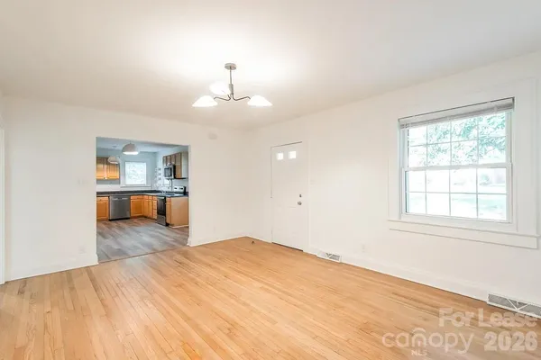 a large kitchen with stainless steel appliances granite countertop a sink dishwasher stove and a microwave oven with wooden floor